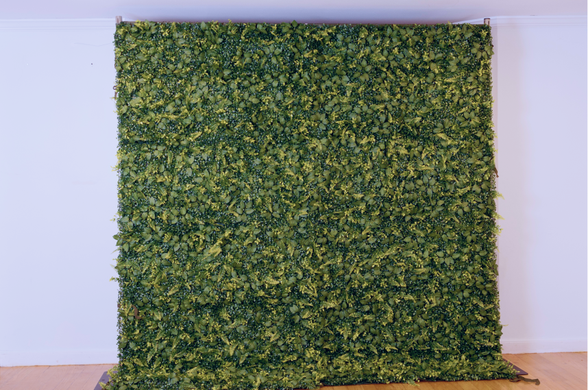 Artificial green grass panel on a white wall